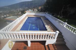 a balcony with a swimming pool on a house at Finca las Aguelillas in La Orotava