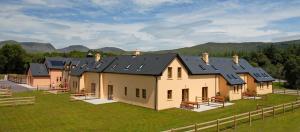 a house with solar panels on top of it at Eclipse Holiday Homes & Adventure Centre in Kenmare