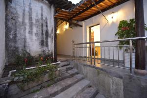 a set of stairs leading to a building with a balcony at Wuzhen On Memory Inn in Tongxiang