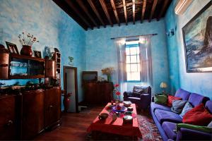a blue living room with a couch and a table at Hotel Rural 4 Esquinas in San Miguel de Abona