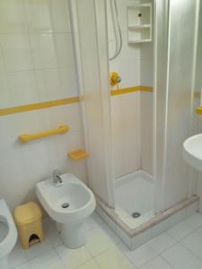 a bathroom with a shower and a toilet and a sink at Il Mulino in San Vito lo Capo