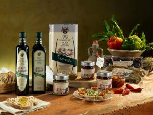 a table with some bottles of wine and some food at Agriturismo Frantoio Mafrica in Limbadi