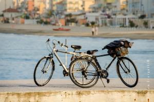 a bike parked on a sidewalk next to a beach at Le Stanze del Pescatore in Bellaria-Igea Marina