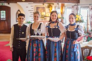 eine Gruppe von vier Personen mit Weingläsern in der Unterkunft Kaisers Tanne - Premium Alles Inklusive Hotel in Breitnau