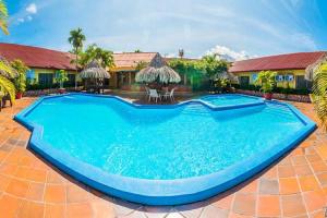 a swimming pool in the middle of a house at Hotel La Quinta in La Ceiba