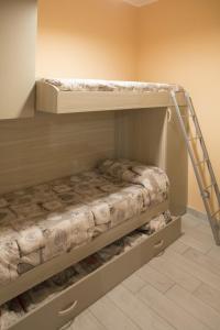 a bunk bed with a ladder in a room at Barone Apartments in Sciacca