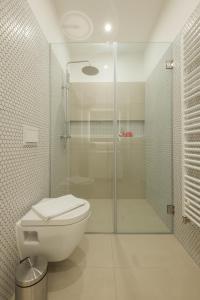 a bathroom with a toilet and a glass shower at Zagreb Sleep & Eat in Zagreb