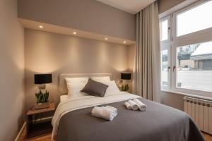 a bedroom with a large bed with two towels on it at Zagreb Sleep & Eat in Zagreb