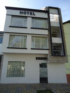 a building with a hotel sign on it at Hotel LB - Los Balsos in Pasto