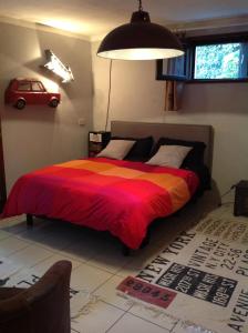 a bedroom with a bed with a red and orange blanket at Villetta in Rio Marina