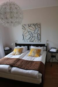 a bedroom with a large bed with two pillows at Villa Ingrid in Borgholm