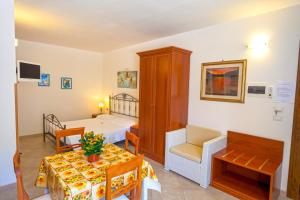 a room with a bed and a room with a table at Agriturismo Masseria Terra D'Otranto in Otranto