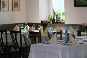 a group of tables with white table cloths and wine glasses at Berg Gasthof Witthoh in Immendingen