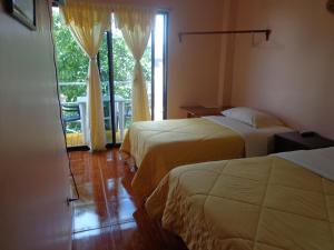 Postel nebo postele na pokoji v ubytování Hostal Nathaly