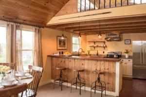 a kitchen with a counter and a table with chairs at The Bradley Inn in New Harbor