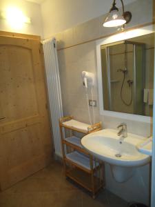 a bathroom with a sink and a mirror and a shower at Appartamenti Camere Agritur Masi Brenta in Rovereto +69 photos