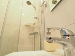 a bathroom with a shower and a sink at Grand Tourist Gemini in Gdańsk +17 photos