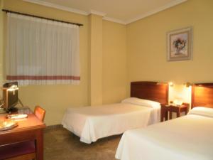 Cama o camas de una habitación en Hotel Isabel