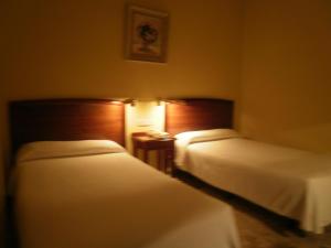 Postel nebo postele na pokoji v ubytování Hotel Isabel