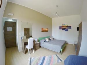 a bedroom with a bed and a desk and a table at Vigne al Vento in Birgi Vecchi