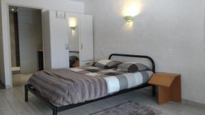 a bedroom with a bed with two pillows on it at Hôtel - Gîte de Pressins in Pressins