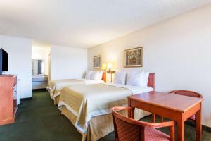 a hotel room with two beds and a table at Travel Inn - Mesa in Mesa