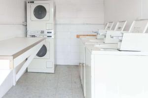 a white laundry room with white washing machines at Days Inn by Wyndham Luray Shenandoah in Luray