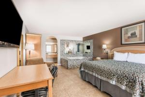 a hotel room with two beds and a table at Days Inn by Wyndham New Braunfels in New Braunfels