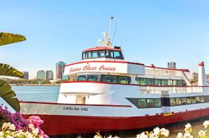 a red and white ferry boat on the water at Cabana Inn & Suites in Long Beach