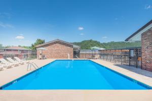 a large swimming pool with blue water at Days Inn by Wyndham Paintsville in Paintsville