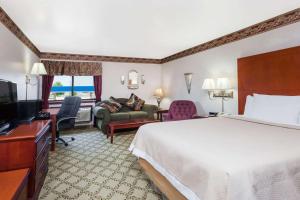 a hotel room with a bed and a television at Days Inn by Wyndham Dyersburg in Dyersburg