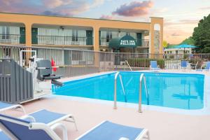 a swimming pool in front of a hotel at Days Inn by Wyndham Clayton in Clayton