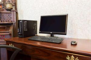 a computer monitor and a keyboard and mouse on a desk at Days Inn by Wyndham Battlefield Rd/Hwy 65 in Springfield