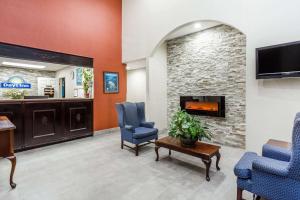 a waiting room with two chairs and a fireplace at Days Inn by Wyndham Hendersonville in Hendersonville