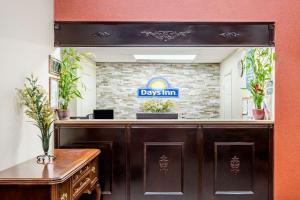 a sign that reads days inn in a mirror at Days Inn by Wyndham Hendersonville in Hendersonville