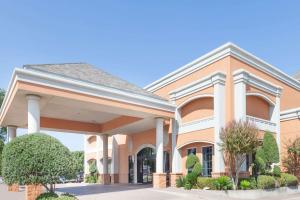 a rendering of the front of a building at Days Inn by Wyndham Irving Grapevine DFW Airport North in Irving