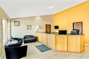 a hotel room with a lobby with chairs and a bar at Days Inn by Wyndham Carson City in Carson City
