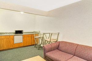 a living room with a couch and a kitchen at Days Inn by Wyndham Carson City in Carson City