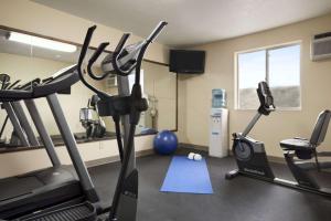 a gym with two tread machines and a treadmill at Days Inn & Suites by Wyndham Gunnison in Gunnison