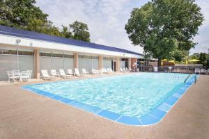 a large swimming pool in front of a building at Days Inn by Wyndham Dubuque in Dubuque