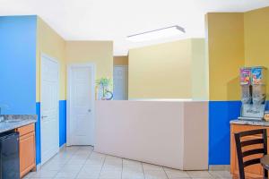 a kitchen with colorful walls and a counter at Days Inn by Wyndham Moulton in Moulton +18 photos