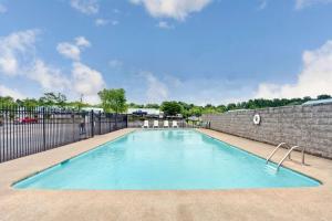 a swimming pool in front of a brick wall at Days Inn by Wyndham Joelton/Nashville in Joelton