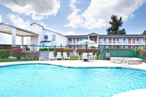 a swimming pool in front of a building at Days Inn by Wyndham Kerrville in Kerrville