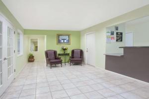 a hallway with two chairs and a table in a building at Days Inn by Wyndham Kerrville in Kerrville