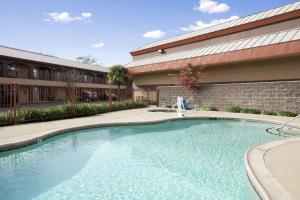 a swimming pool in front of a building at Days Inn by Wyndham Rocklin/Sacramento in Rocklin