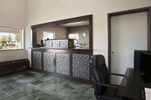 a room with a mirror and a table and a chair at Days Inn by Wyndham Rocklin/Sacramento in Rocklin