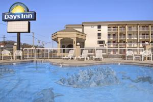 a large swimming pool in front of a hotel at Days Inn by Wyndham Apple Valley Pigeon Forge/Sevierville in Pigeon Forge