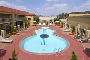 a large swimming pool in a residential area at Days Inn by Wyndham Memphis at Graceland in Memphis