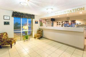 a waiting room at a pharmacy with chairs and a counter at Days Inn by Wyndham Richmond in Richmond