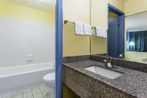 a bathroom with a sink, toilet and shower at Days Inn by Wyndham Dickson in Dickson